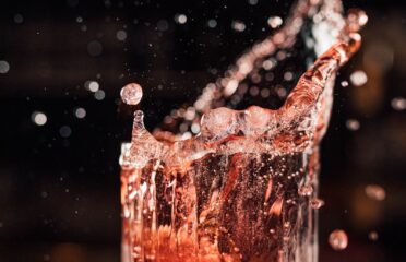 a glass filled with water on top of a wooden table